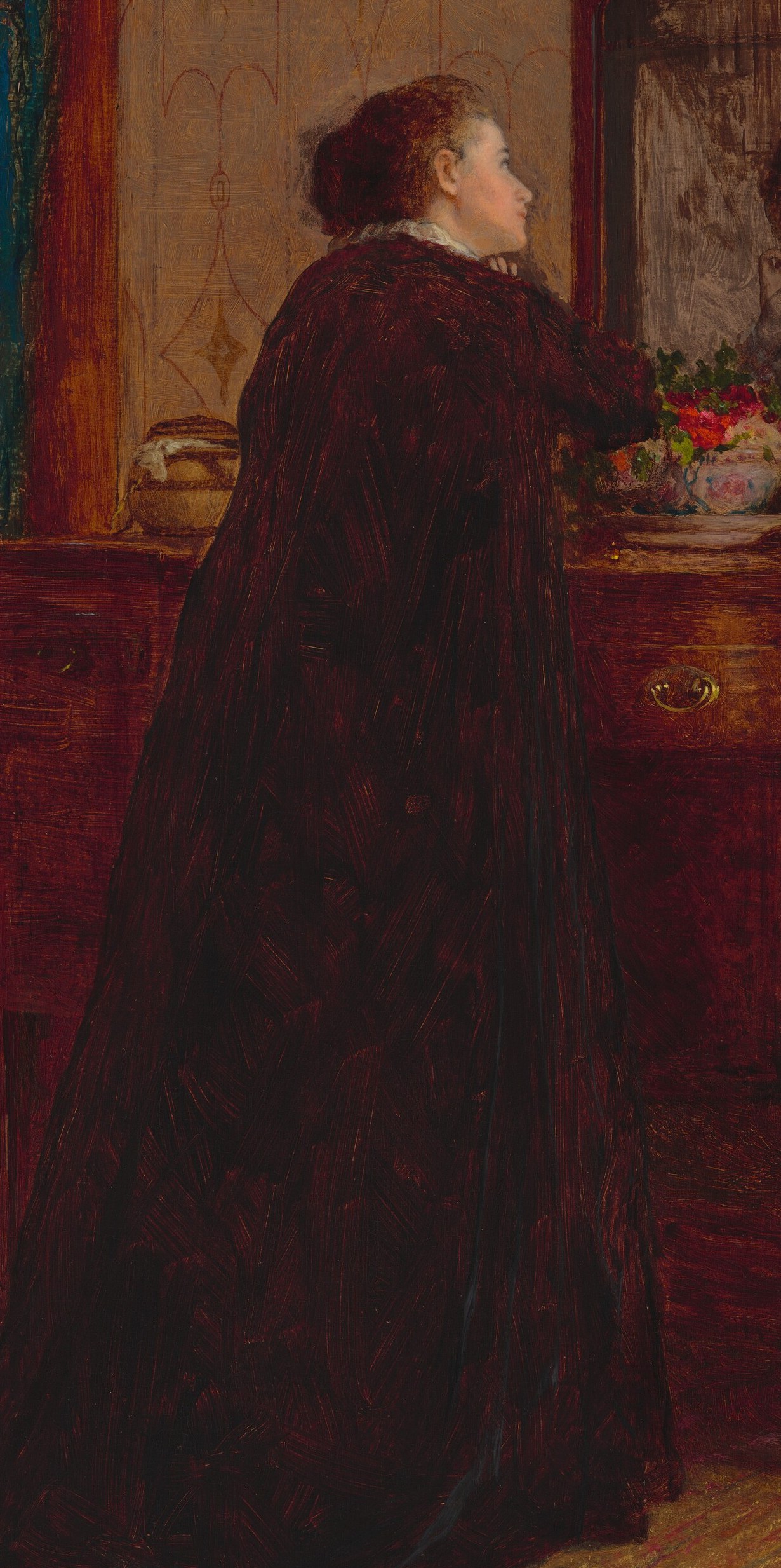 She stands before a dresser, lost in her thoughts.