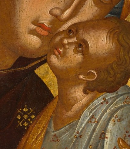 His tiny hand clings to her veil.