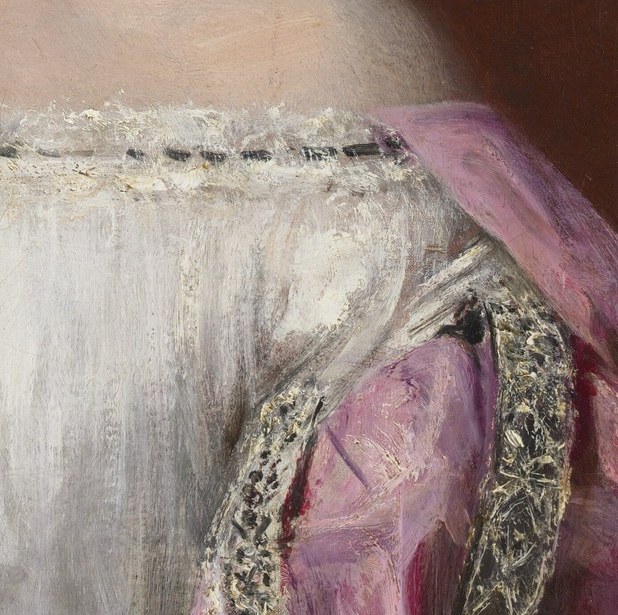 Her white dress shows delicate lace trim.