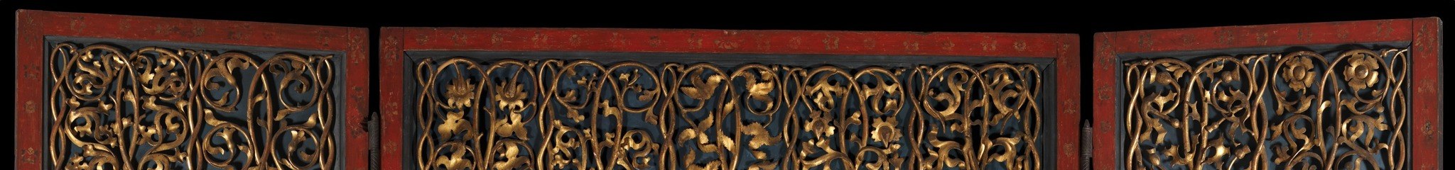 A single Late Gothic decorative register that visually stitches together three separate panels; gold tendrils against dark ground create a celestial ceiling marking the space below as sacred and outside earthly time