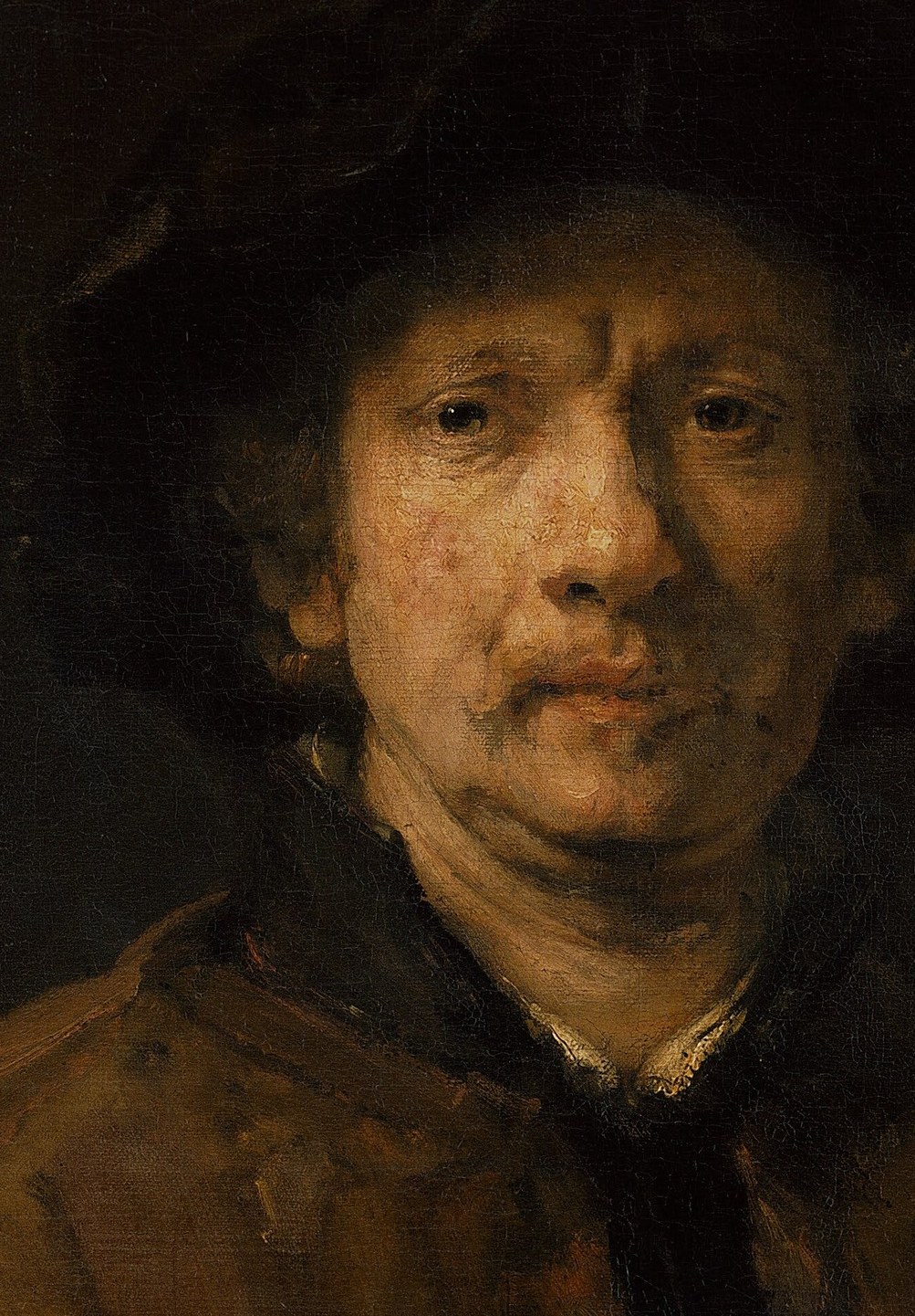 The dramatic play of light and shadow sculpts the face, emphasizing its contours and emotional depth.