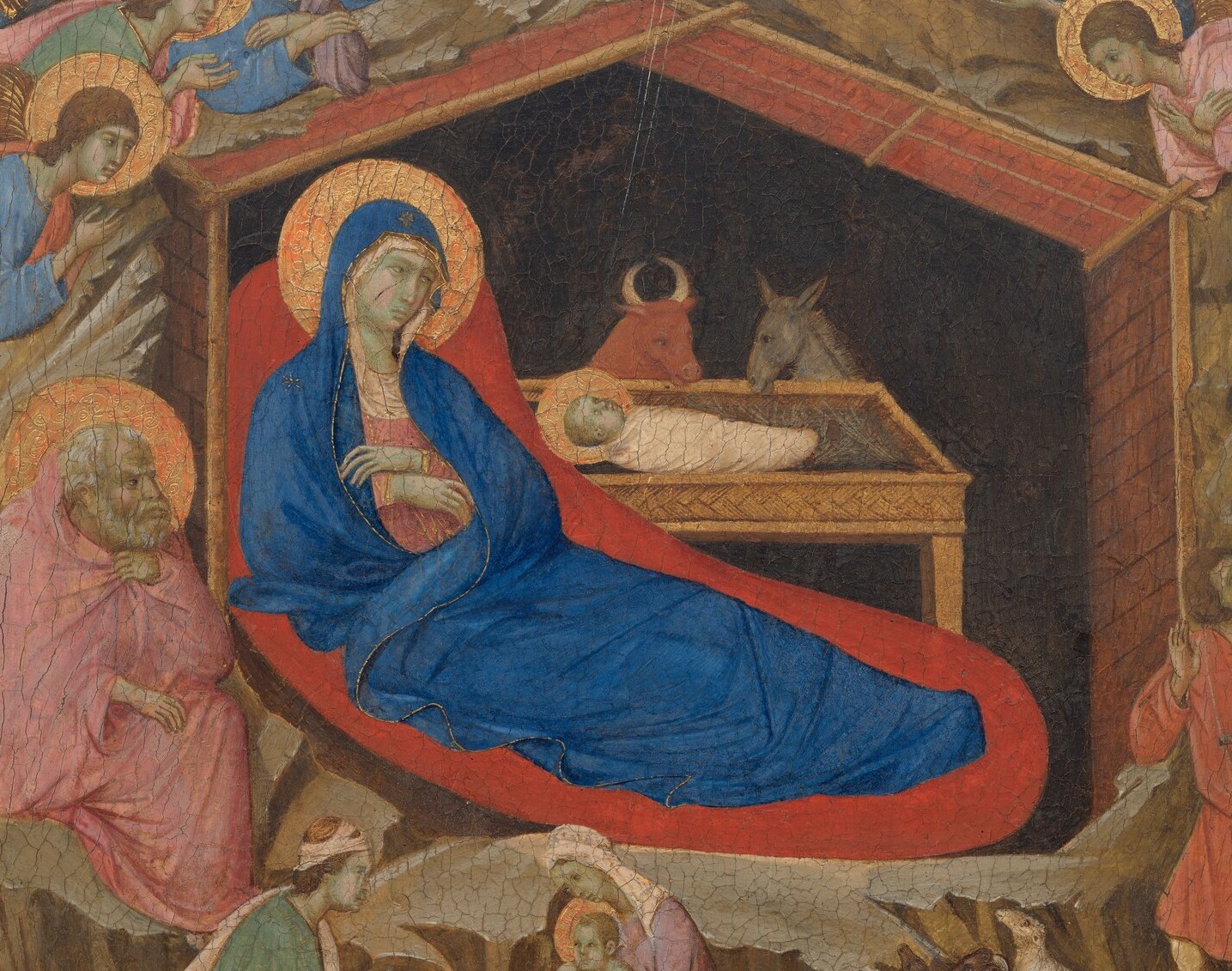 Mary in blue. A gold sky. The Christ child in a manger.