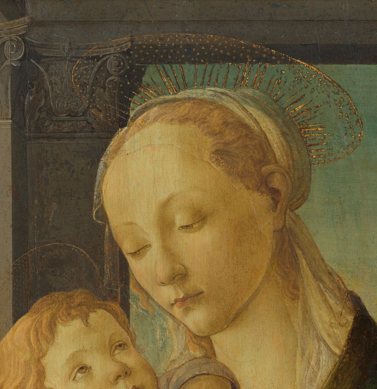 A young mother holds her child in a sacred space.