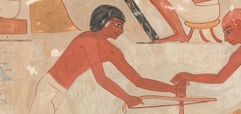 Here, one carpenter uses a bow drill to shape wood.