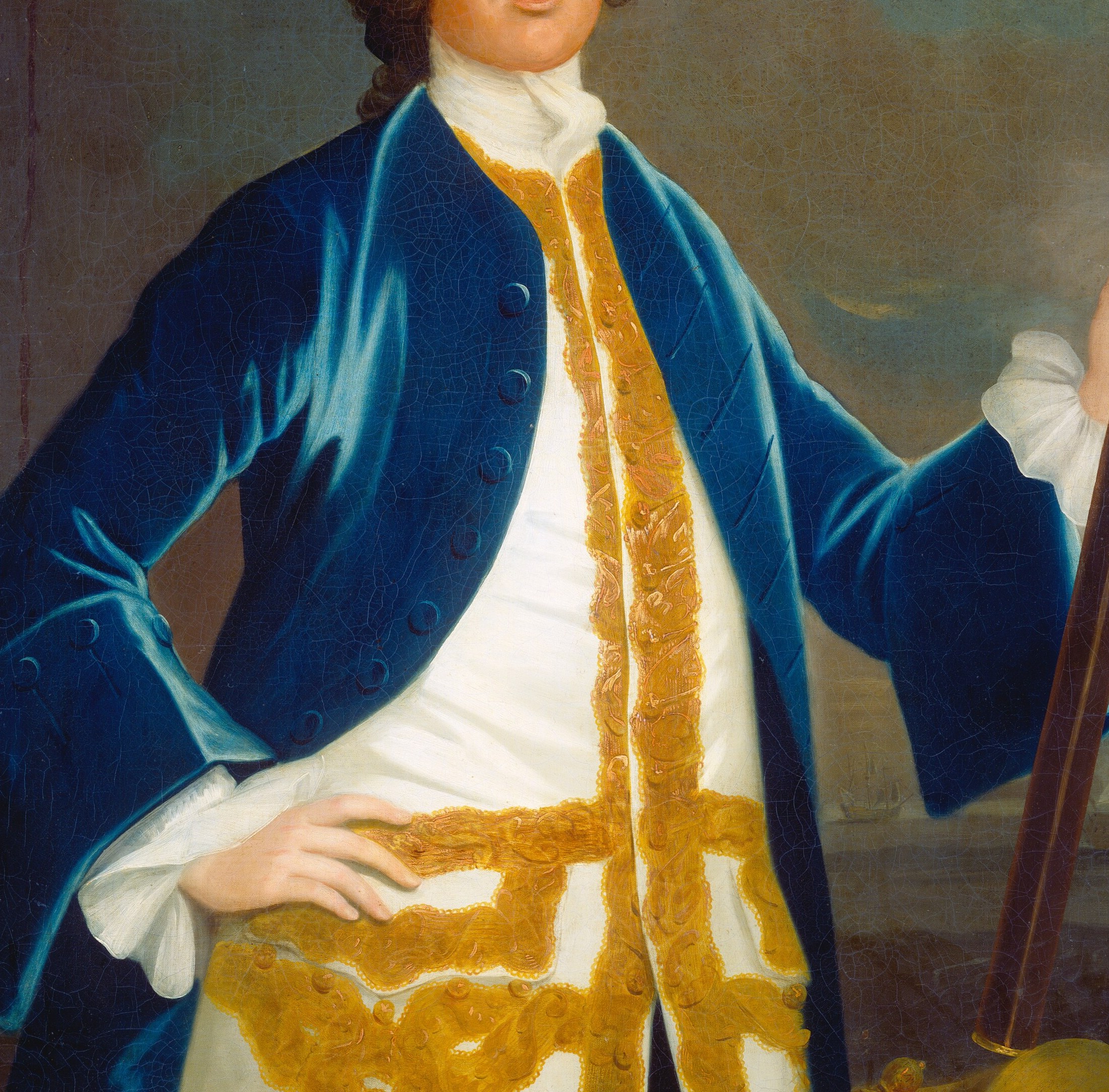 His uniform is rich, with a blue coat and gold trim.