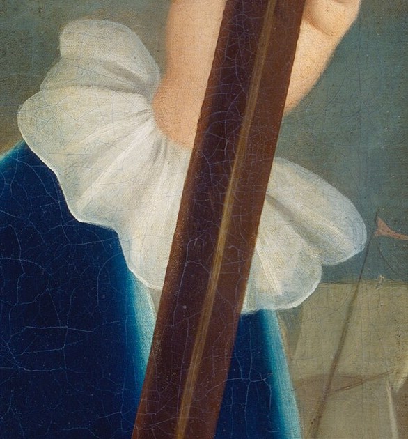 Look closely at his white ruffled cuff.