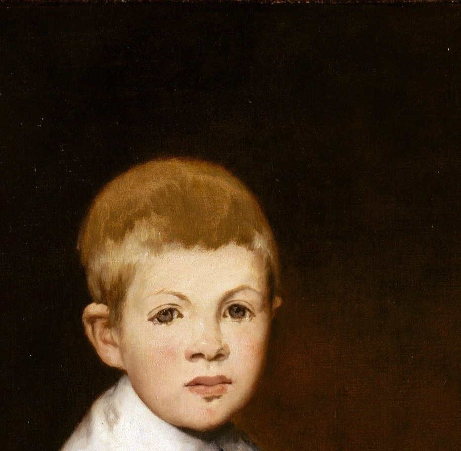 A small boy dressed like a Spanish prince from another century.