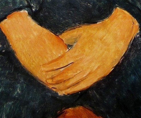 His hands rest in a quiet, still pose.
