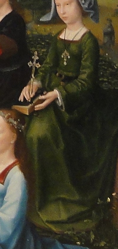 Her serene expression and the cross suggest piety and martyrdom.