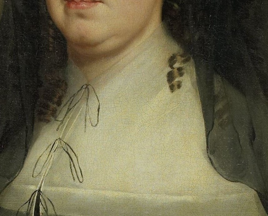 Notice the dark gown and crisp white ruff collar.