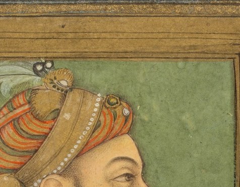His elaborate turban and feather signify his royal status.