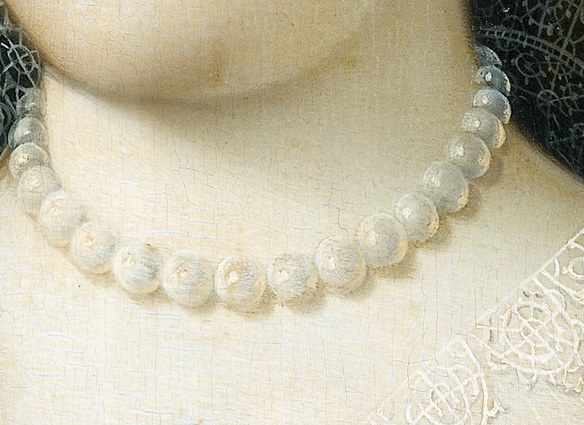 The pearls in her necklace and earring were also symbols of wealth.