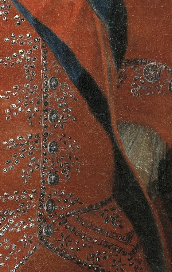 Look closely at the intricate silver embroidery on his lapel.
