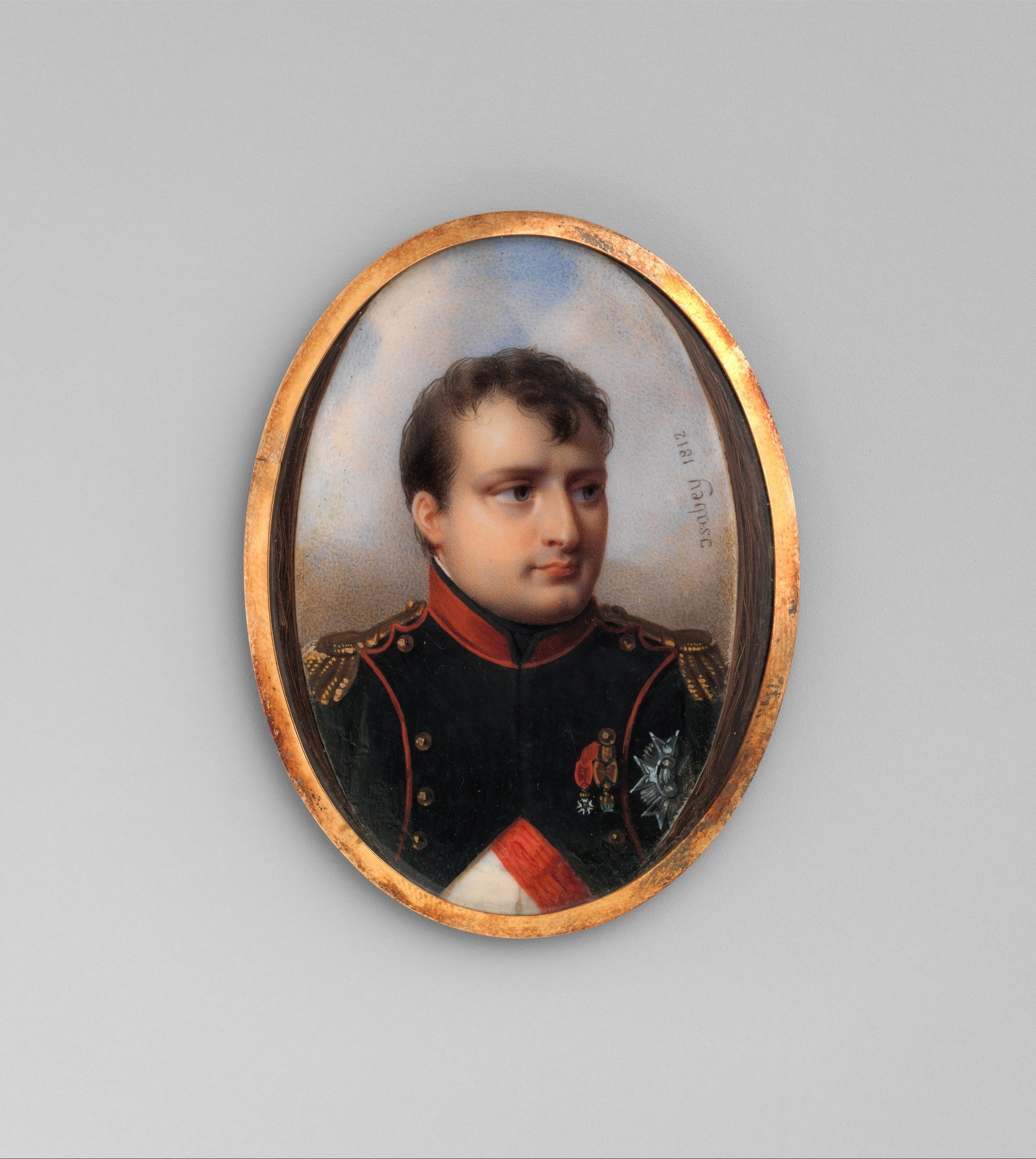 The frame is itself an artifact of Empire taste , its burnished gold signals the object's function as a gift or diplomatic token rather than wall art, a hidden social context.
