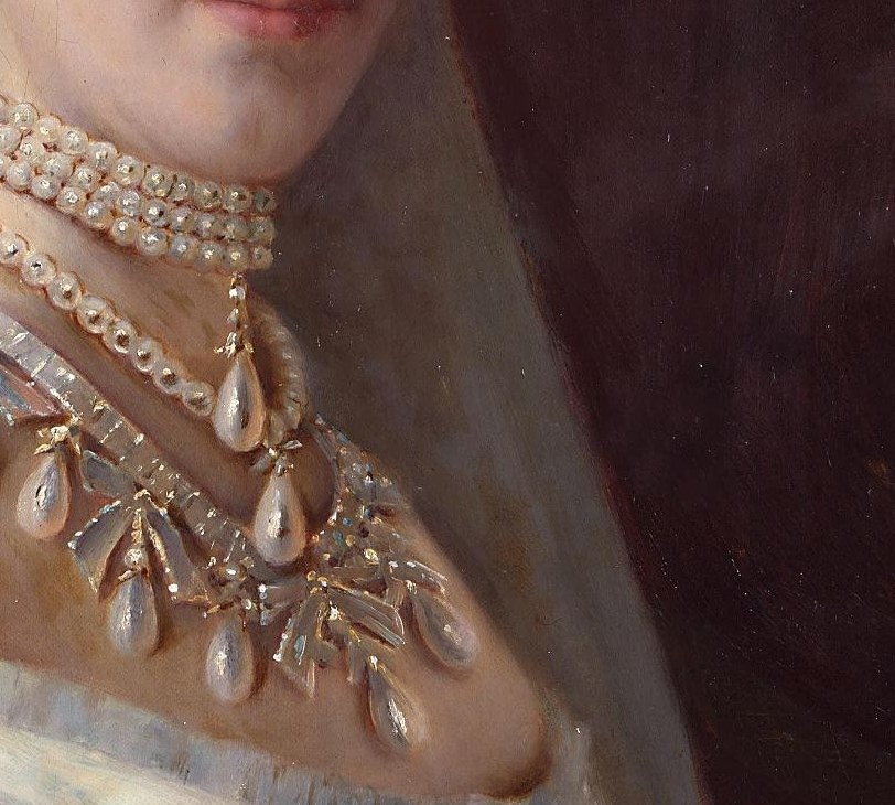 Every pearl in her necklace catches the light.