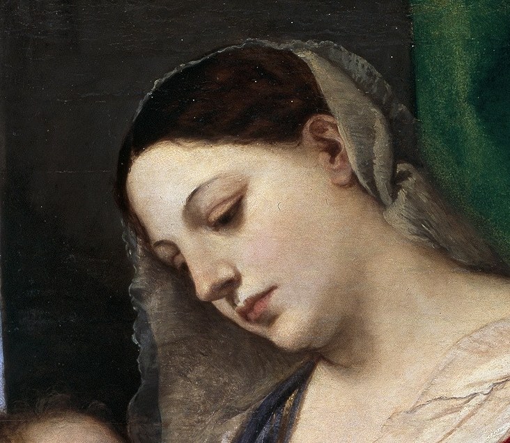 Downcast eyes and parted lips suggest absorbed tenderness rather than generic serenity, a living mother absorbed in her child.