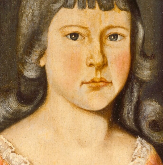 Her expression is solemn, and she looks directly at us.