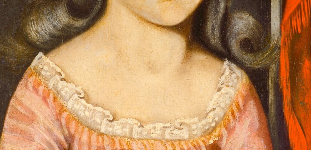 She wears a white sash and delicate lace trim.