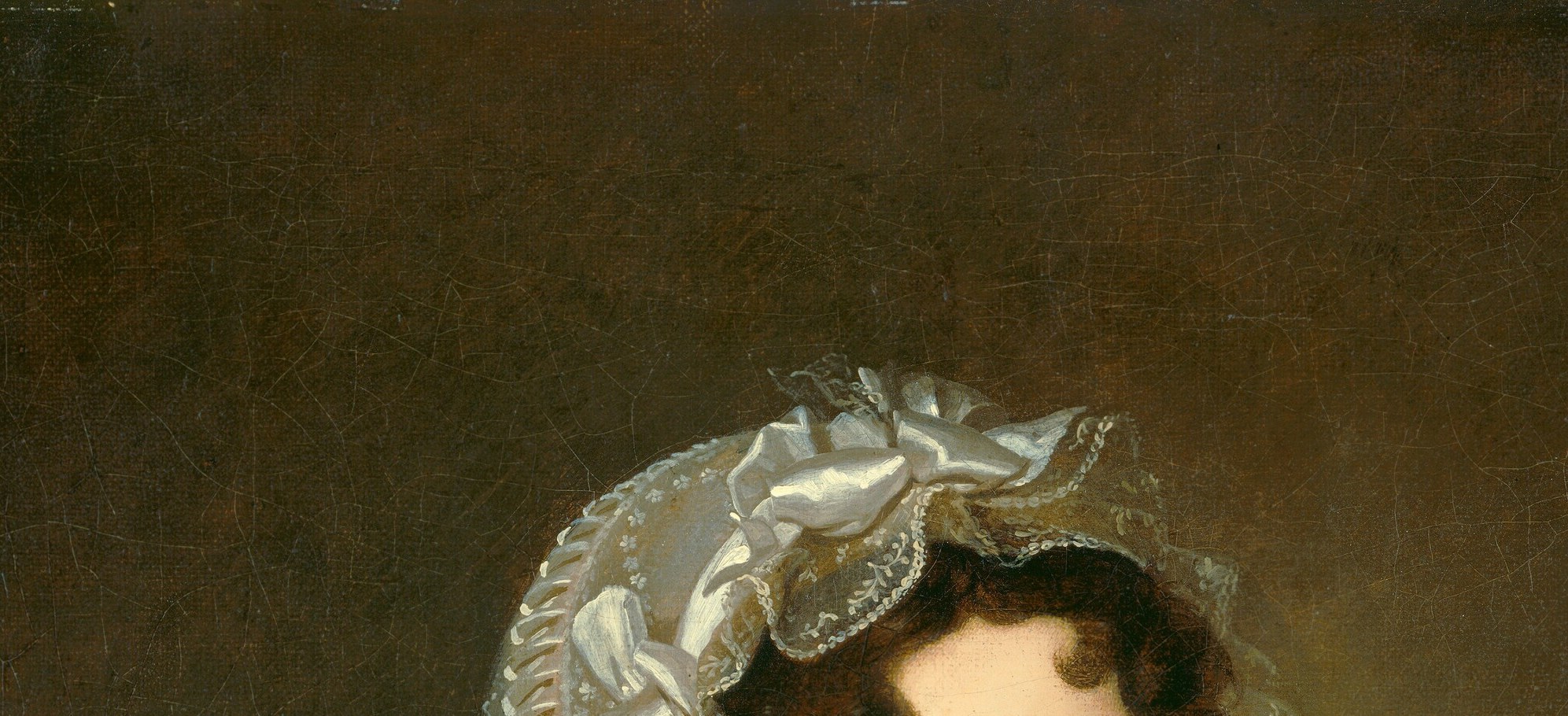 The elaborate lace cap. A signal of domestic respectability.