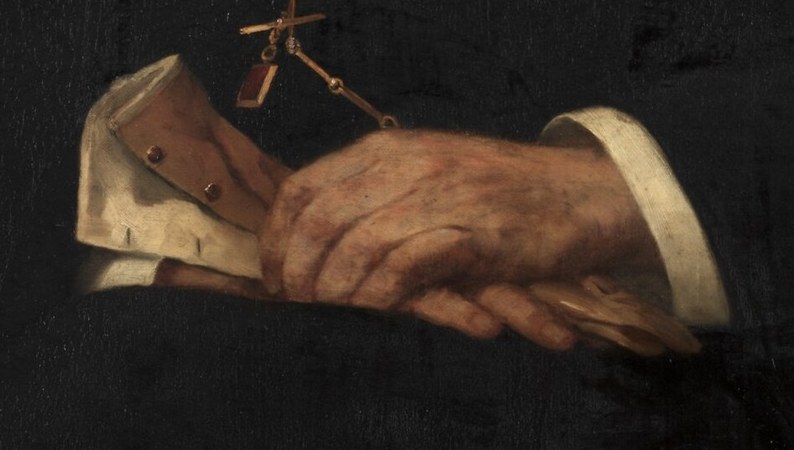 He holds a folded paper, perhaps a document, in his hands.