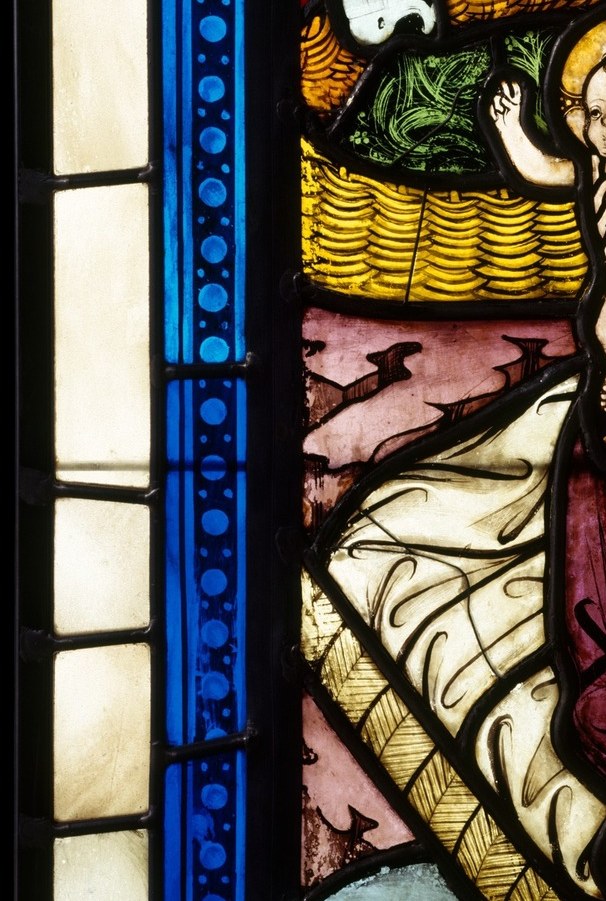 A king kneels in the straw before a newborn.
