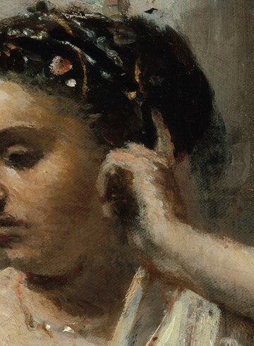 Her gaze is downcast and her expression is introspective, suggesting deep thought or listening.