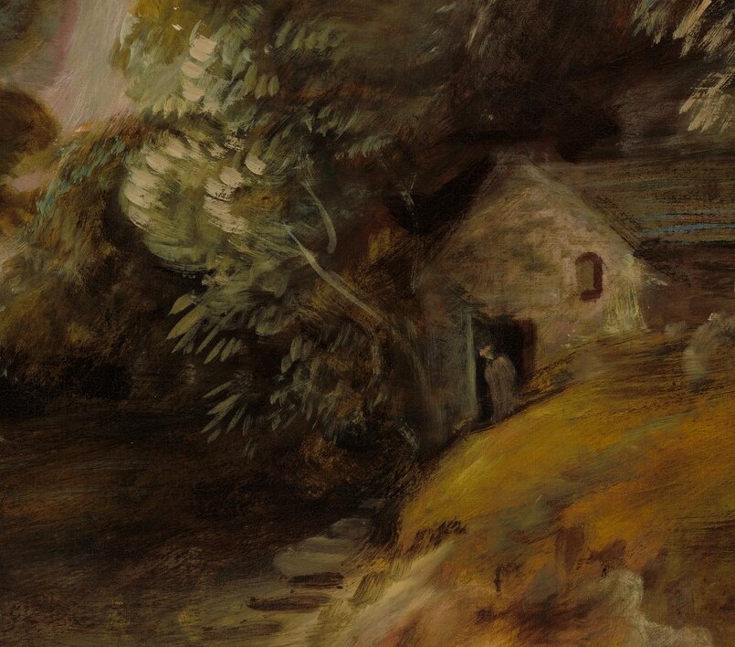 Look for the cottage hidden in the shadow of the cliff.