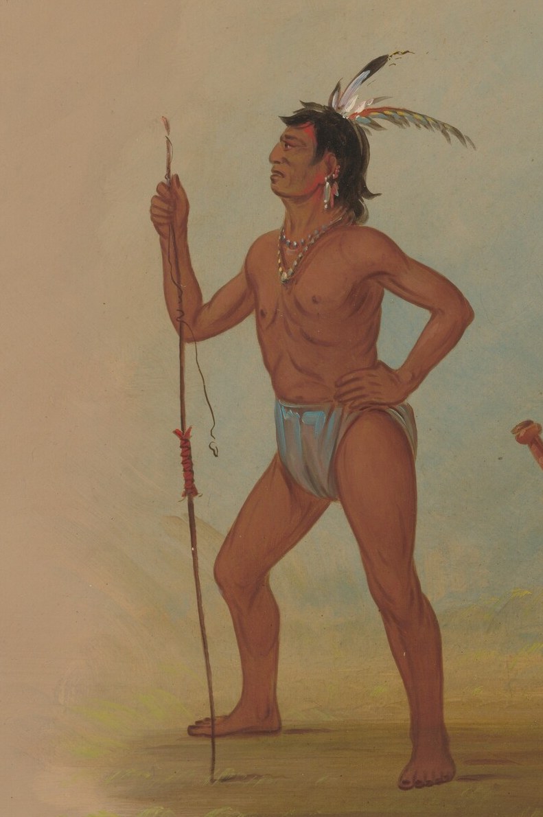 His stance and the spear suggest readiness or a ceremonial pose, offering insight into cultural practices.