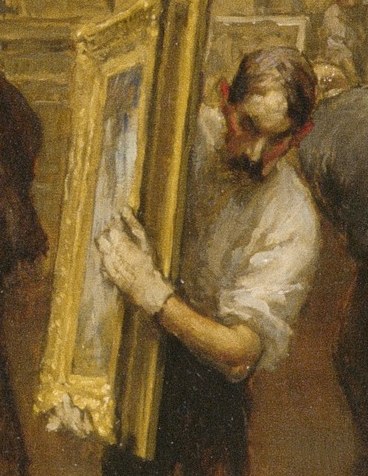 A man holds up a painting for review.