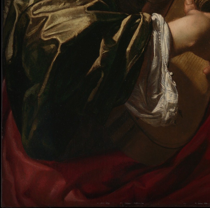 The saturated red breaks dramatically from the brown-gold palette of the rest of the figure; it grounds the composition with a bold chromatic weight.