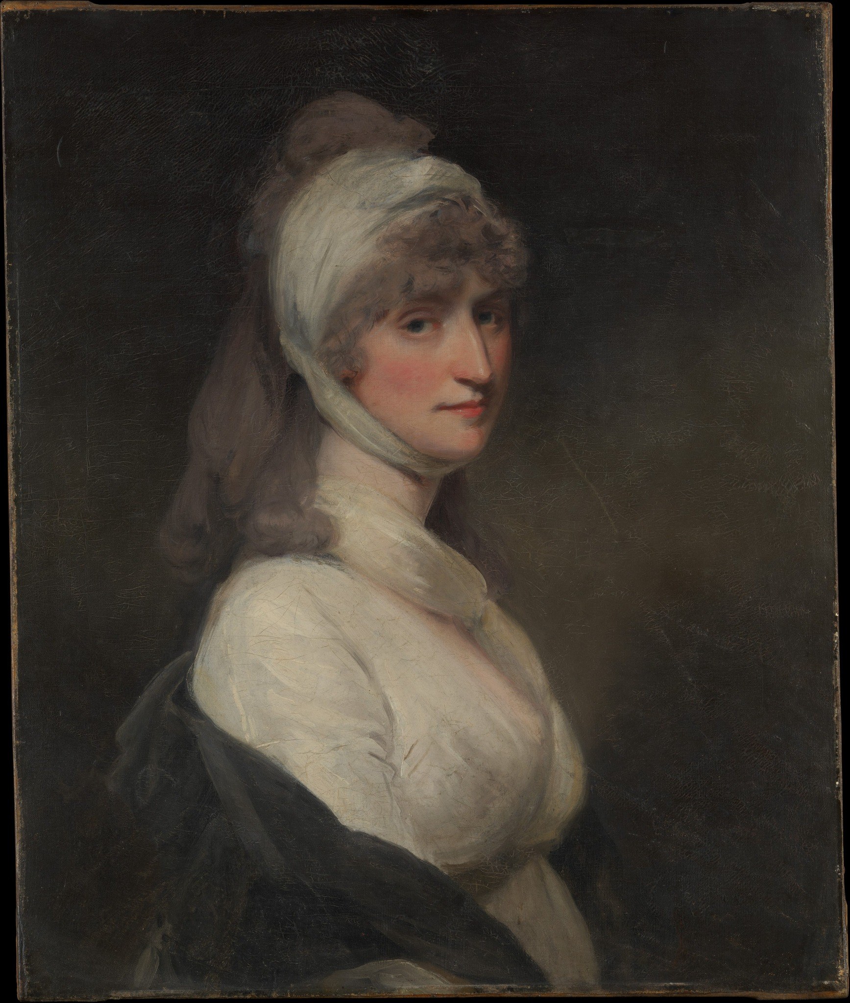 The dark background isolates her face.