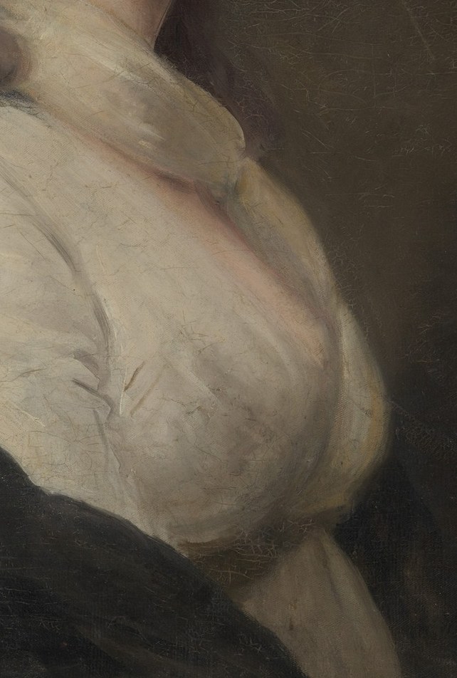 Her white gown has a soft elegance.