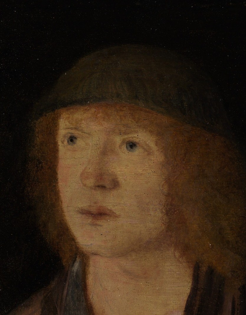 Notice his fair hair and intense, questioning gaze.