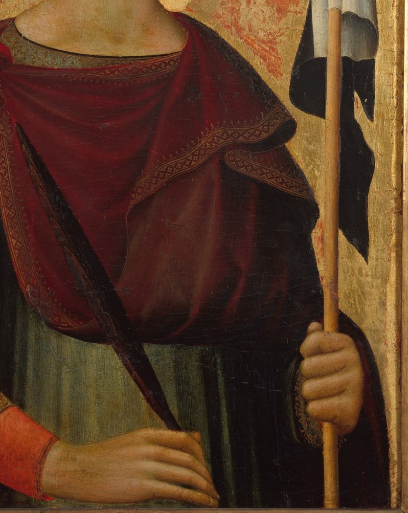 The rich red fabric with gold trim suggests status and importance, drawing the eye with its vibrant color.