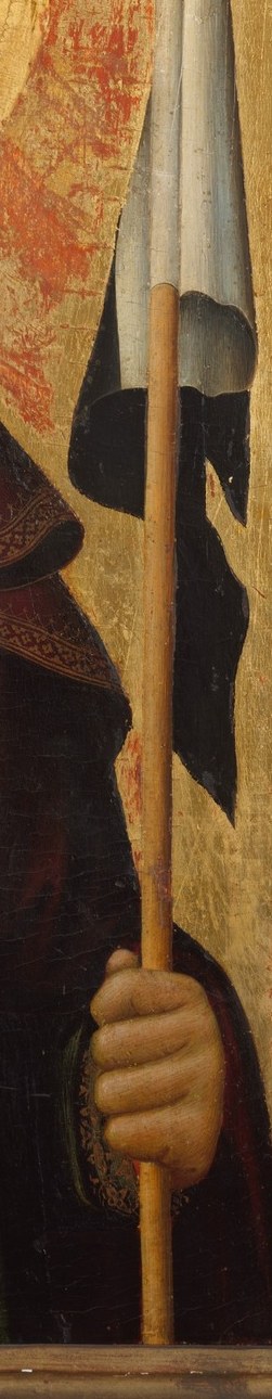 This attribute likely symbolizes martyrdom or a specific aspect of the saint's life and mission.