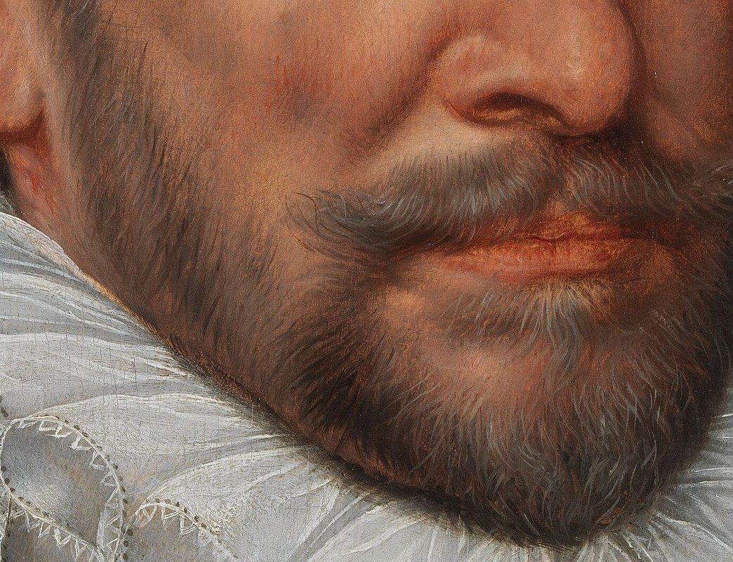 The neatly trimmed beard and mustache add to his dignified and mature appearance.