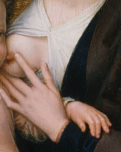 His hand reaches up, for a blessing, or for his mother.