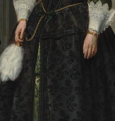 Her glove is held, not worn. A sign of social readiness.