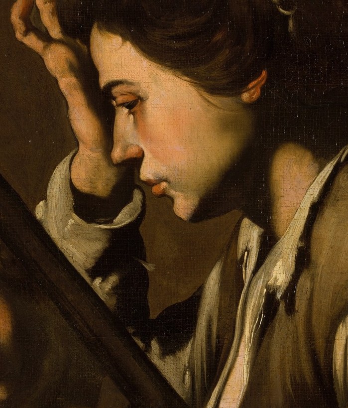 A woman stares intently into a mirror.