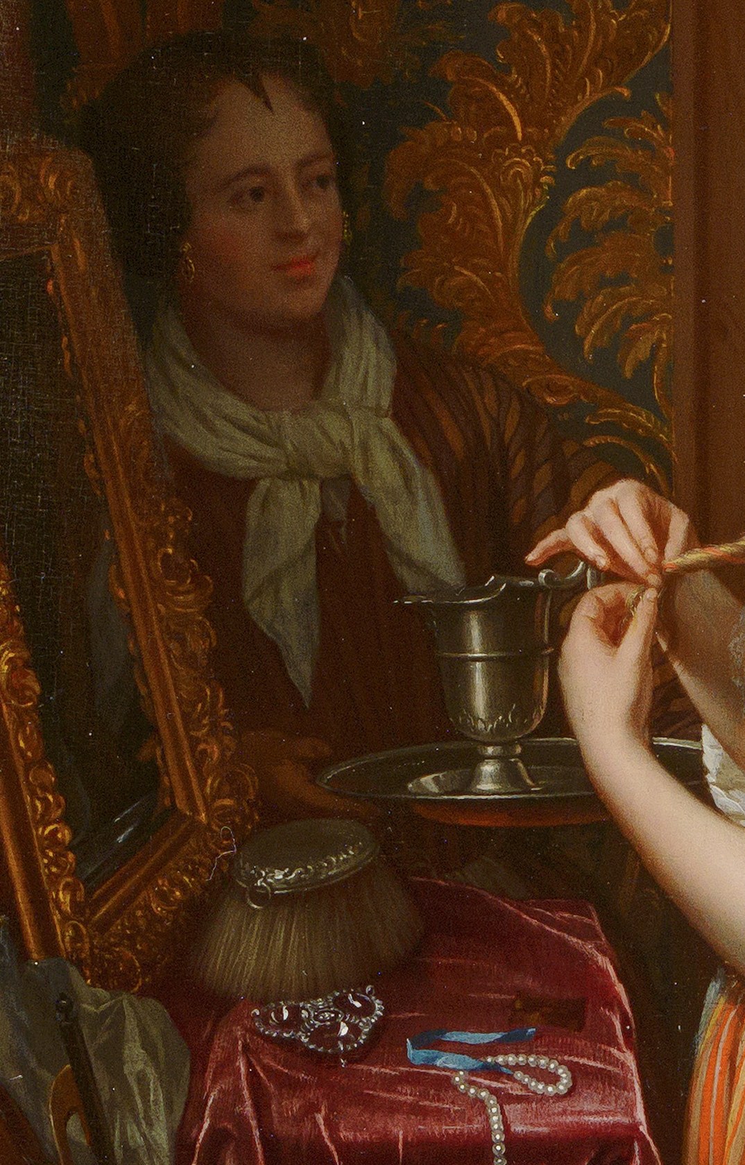 Look at the gold-framed mirror.