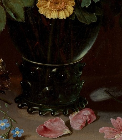 Look closely at the ornate green glass vase.