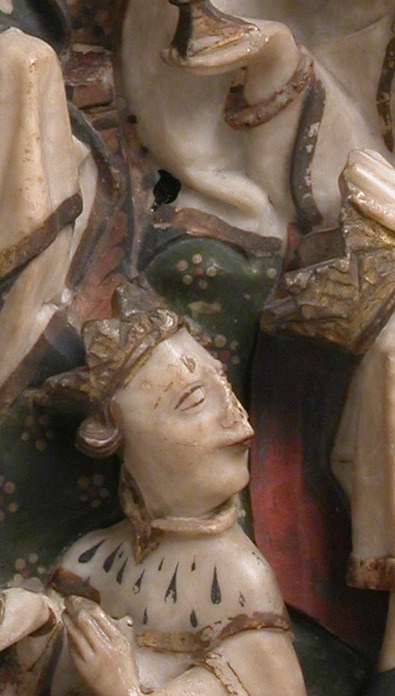 The kneeling king offers his gift with utmost humility.