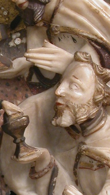 His regal bearing and gesture of presenting a chalice suggest his royal status and the significance of the offering.