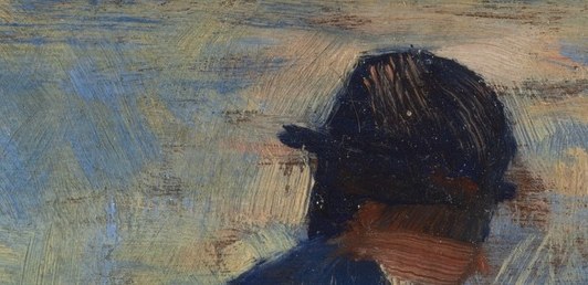 His dark hat shades his face, hiding his gaze.