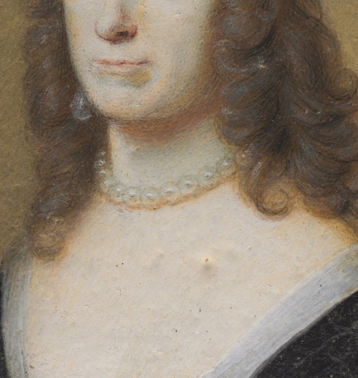 The soft, flowing curls frame her face, contributing to the overall impression of elegance and youth.