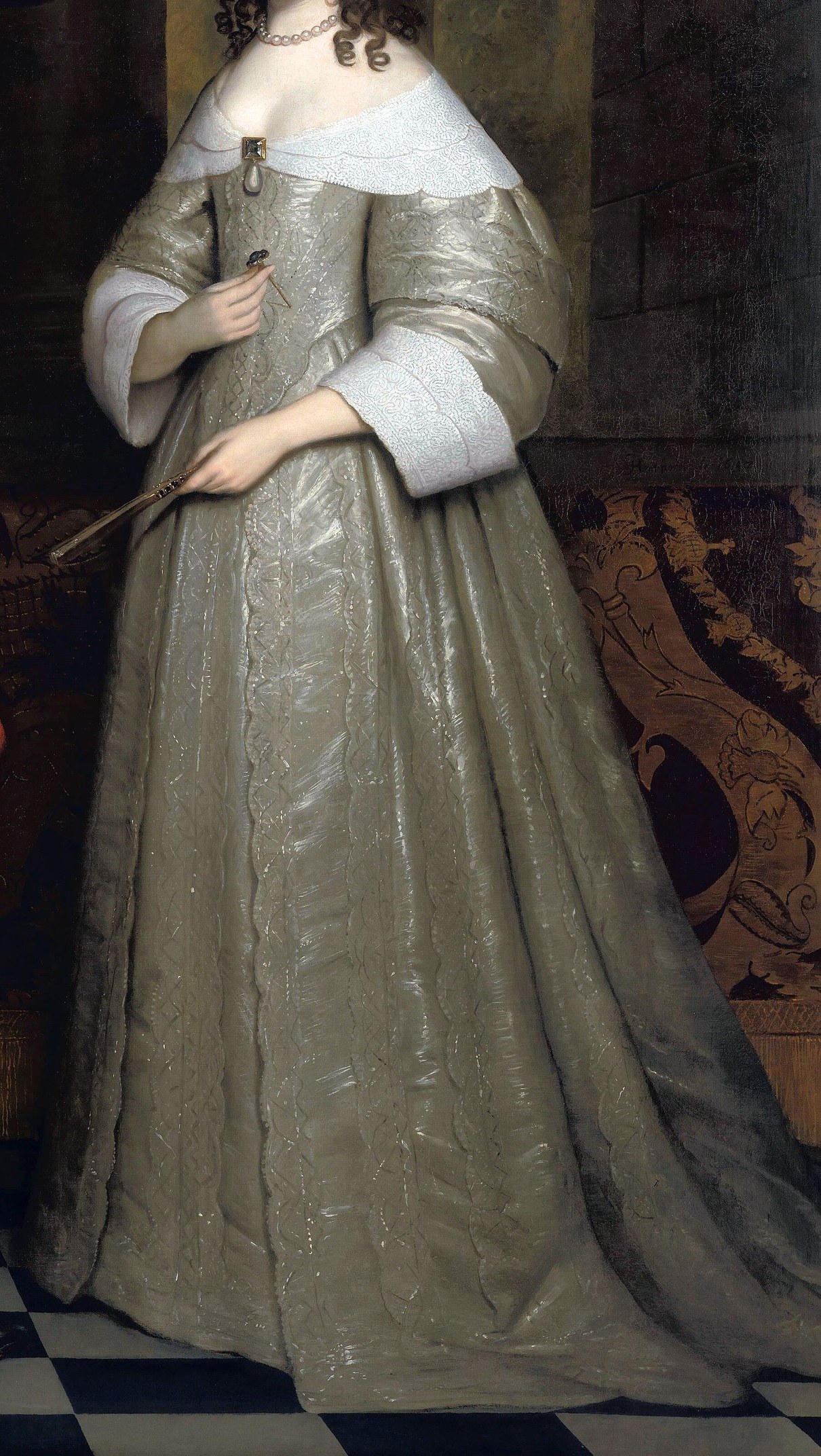His wife's brocade dress seems to gleam from within.