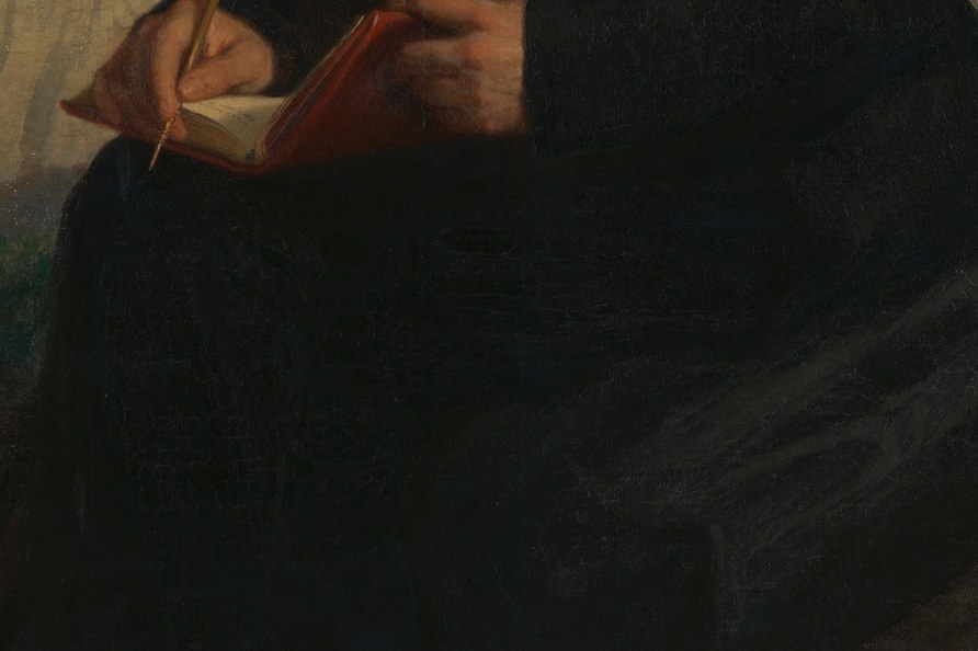 An open notebook. He is still working, mid-thought, mid-sentence.