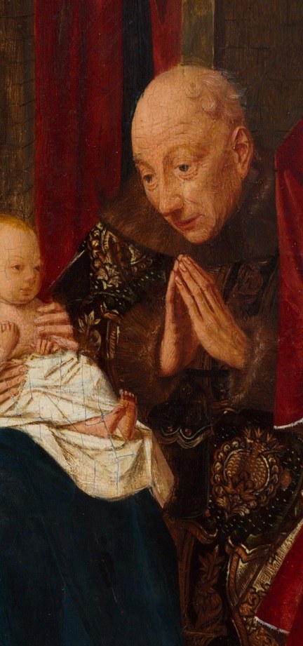 His clasped hands and bowed head show deep reverence and humility before the divine child.