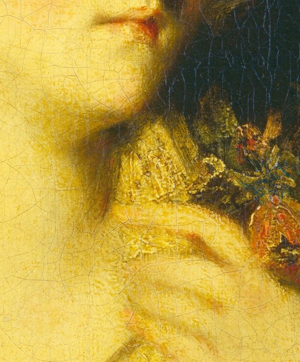 She wears a soft lace collar and holds a small bouquet.
