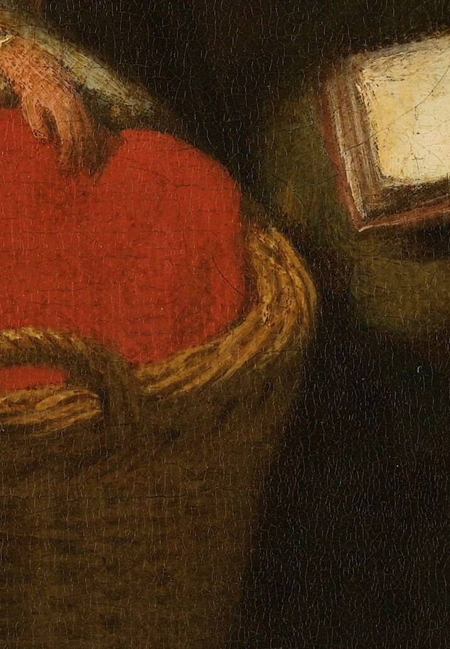 The rich red lining of the cradle provides a striking visual contrast and emphasizes the preciousness of the child.